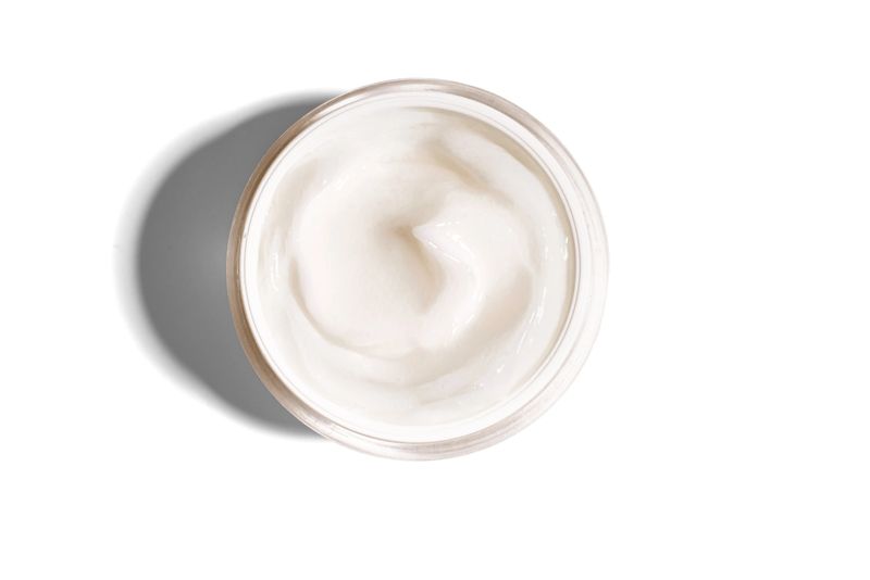Cosmetic cream jar isolated on white background, top view, design element. Open jar of face cream, body butter, beauty product.