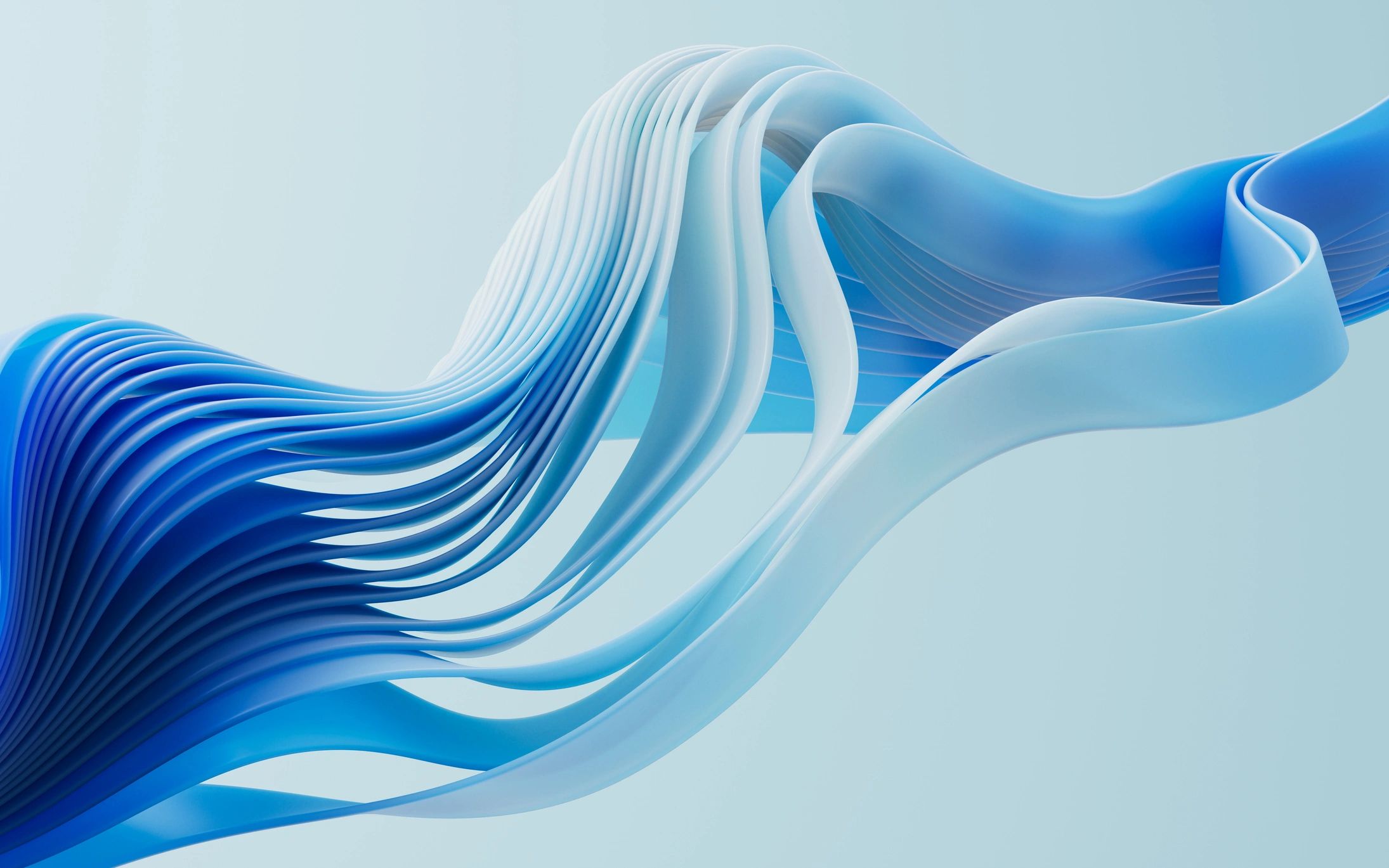 Abstract blue flowing ribbons curling gracefully.