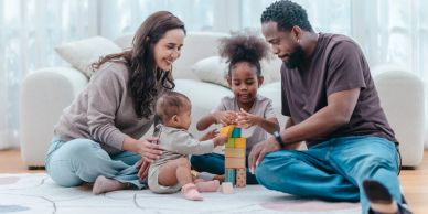 Family playing together with building blocks at home.