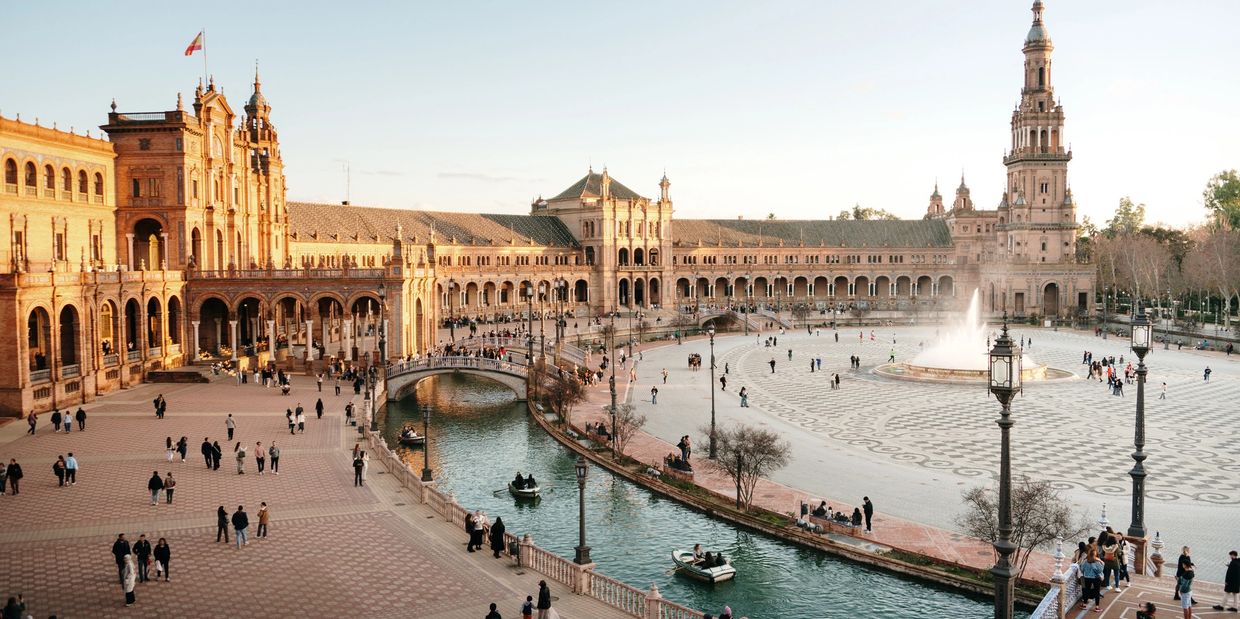 Plaza de España in Seville with a canal and fountain.