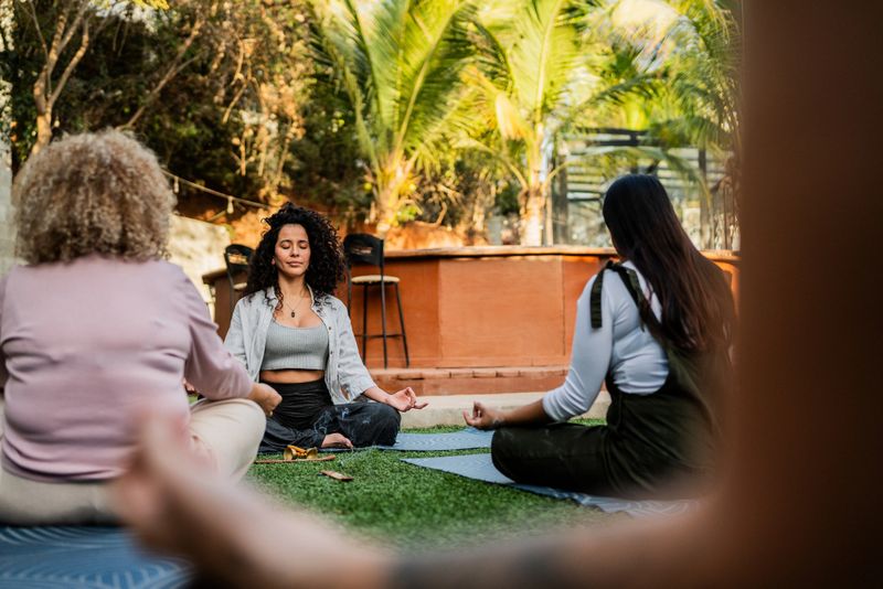 Mid adult instructor woman during meditation session during a spiritual retreat