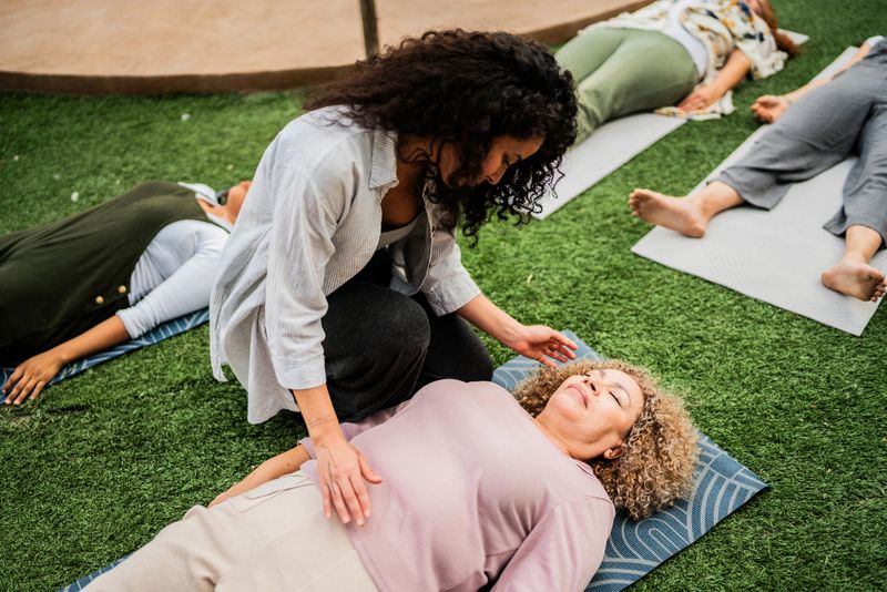 Mid adult instructor woman during meditation session during a spiritual retreat