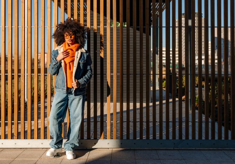 Fashionable woman with afro embracing modern city vibes