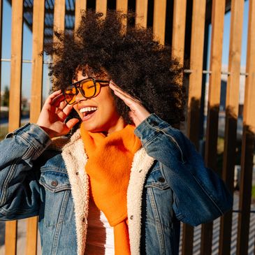 Happy woman with sunglasses and curly hair.