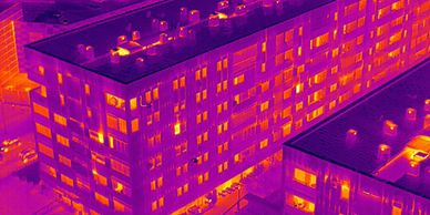 Thermal image of a building showing heat distribution with warm spots.