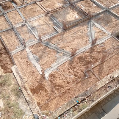 Early stage foundation work with steel reinforcement on a construction site.
