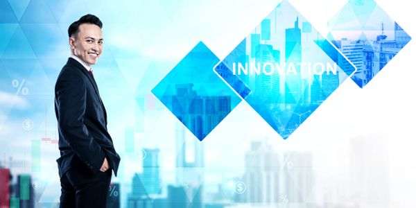 A businessman smiling with innovation concept graphics.