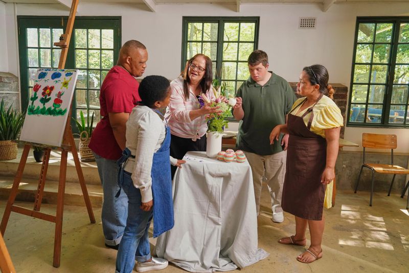 People with various disabilities arranging flowers during art classes in art studio