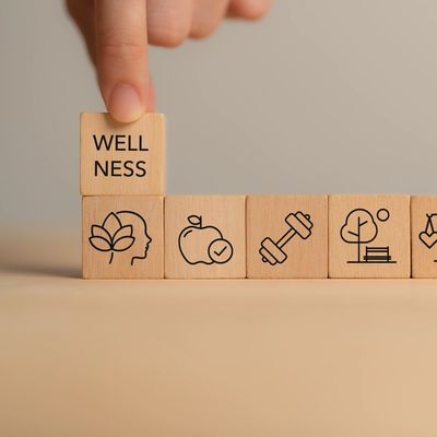 Wooden blocks depicting wellness and healthy lifestyle concepts.