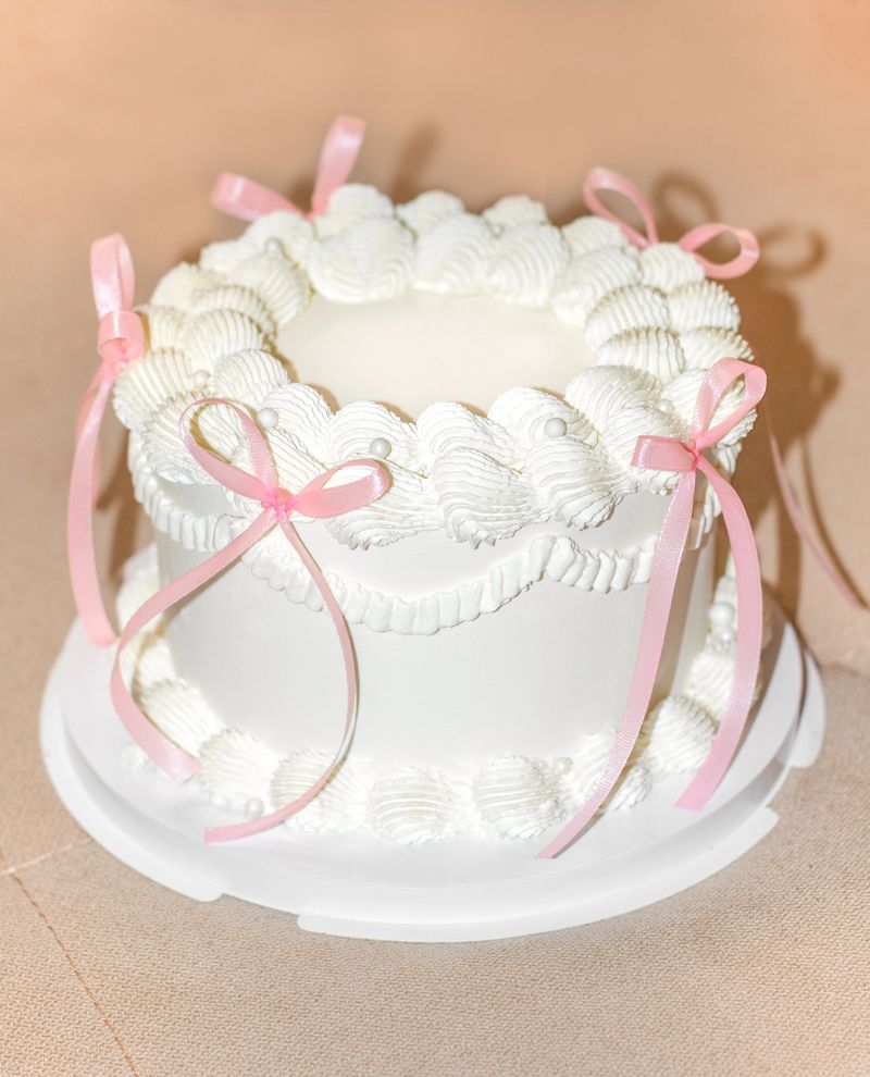 vintage cake with pink bows of delicate cream color. High quality photo