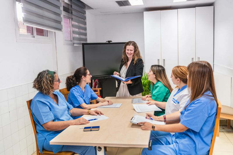 Healthcare professionals in a nursing home setting meet to discuss strategies for improving patient care and collaboration