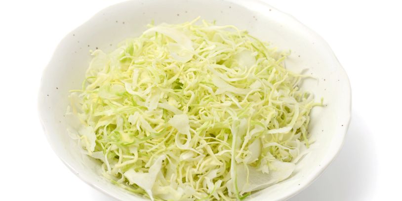 A bowl filled with shredded cabbage.