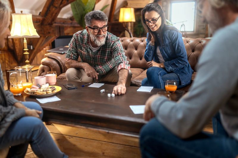 Group of happy seniors having fun while playing family  game at home.
