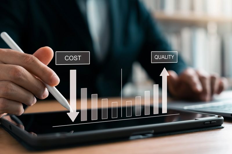 Better quality control and cost reduction, Businessman using laptop and tablet to analyze company growth, arrow graph, business growth and cost reduction in the future efficiently.