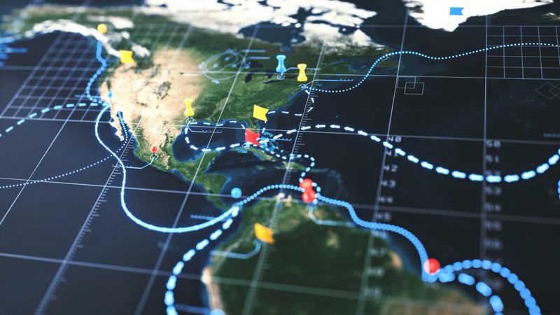 Strategic world map of the Americas with digital infographics overlay, pinned locations and sea routes