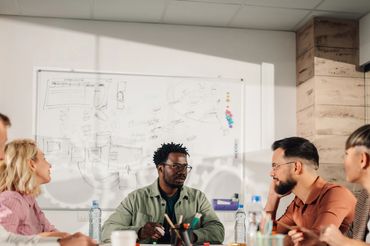 A group of people sitting around a table.