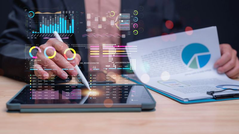 Data Analytics in Action, Professional utilizes tablet to analyze data, modern analytics methods through visual representations and charts