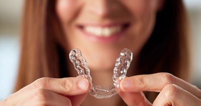 A woman showing Invisalign®