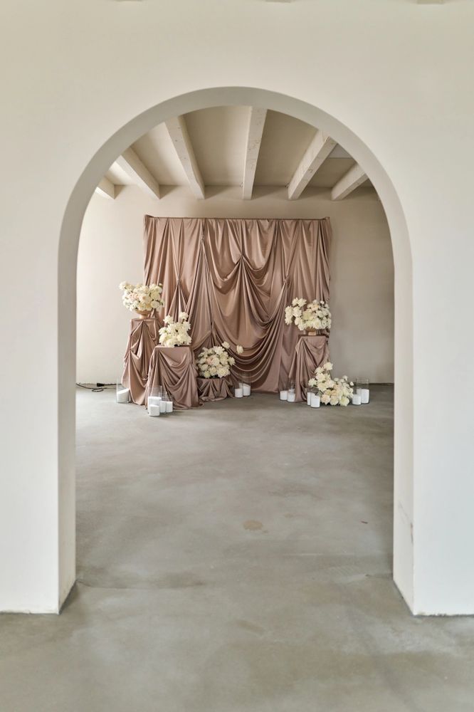 Elegant floral arrangement with draped fabric backdrops to make a statement. 