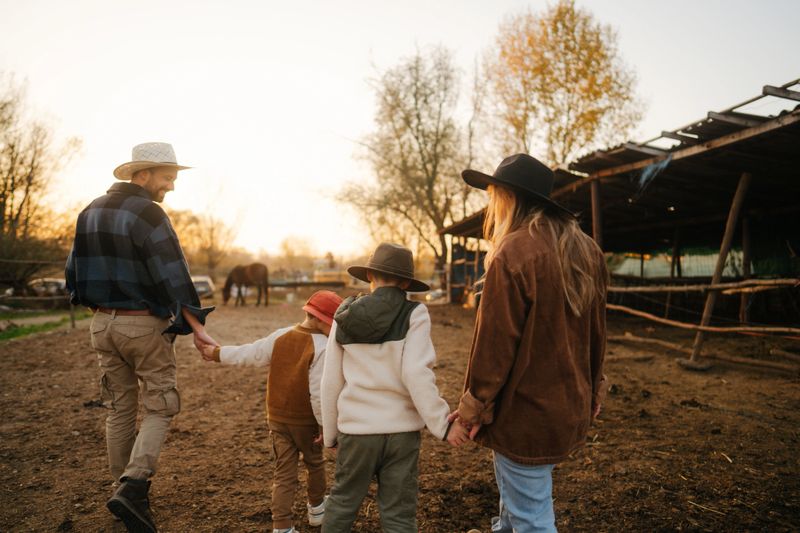 Portrait of a young family at their horse ranch