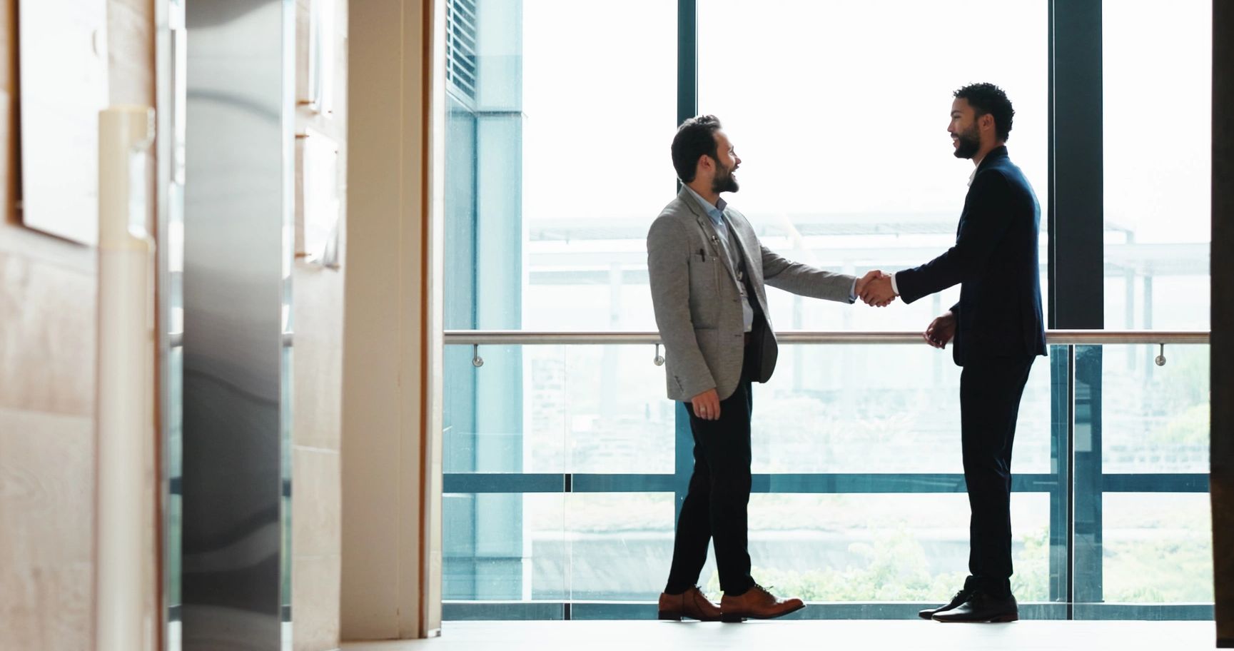 Client shaking hands with lawyer from Stavros Law
