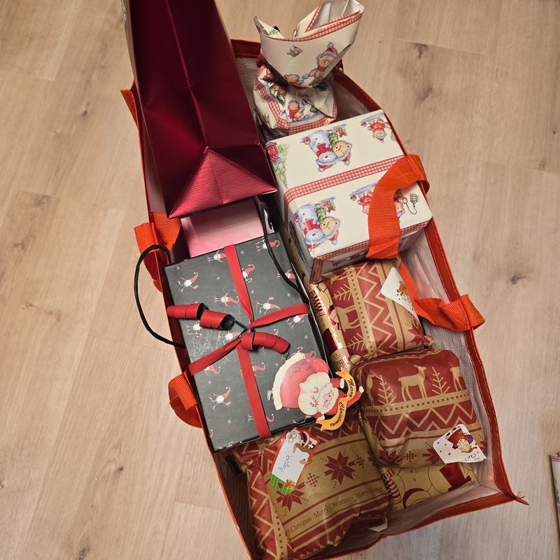 A vibrant and colorful basket overflowing with beautifully wrapped gifts intended for the joyful holiday season