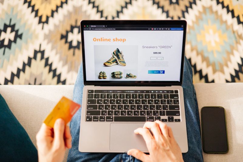 A man enjoys the convenience of buying brand new shoes online