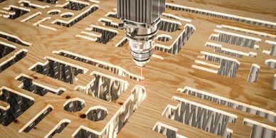 Laser cutting machine engraving intricate patterns on wood.