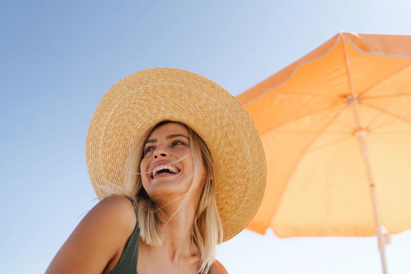 Photo of a woman enjoying hot summer day on the local beach