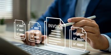 Person interacting with digital invoice and checklist icons above a laptop keyboard.