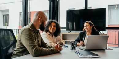 Three colleagues having a meeting in a modern office.