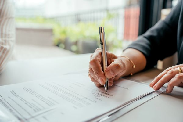 A women siging the insurance papers
