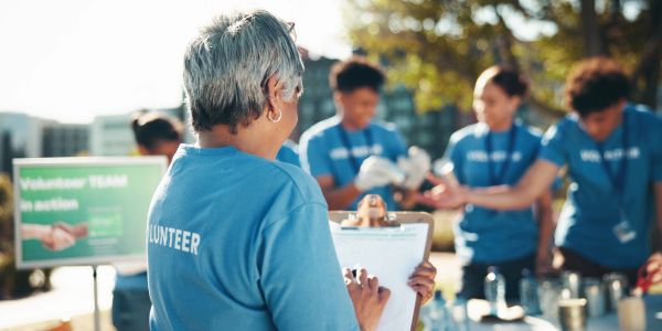 Volunteer managing a team at an outdoor event.