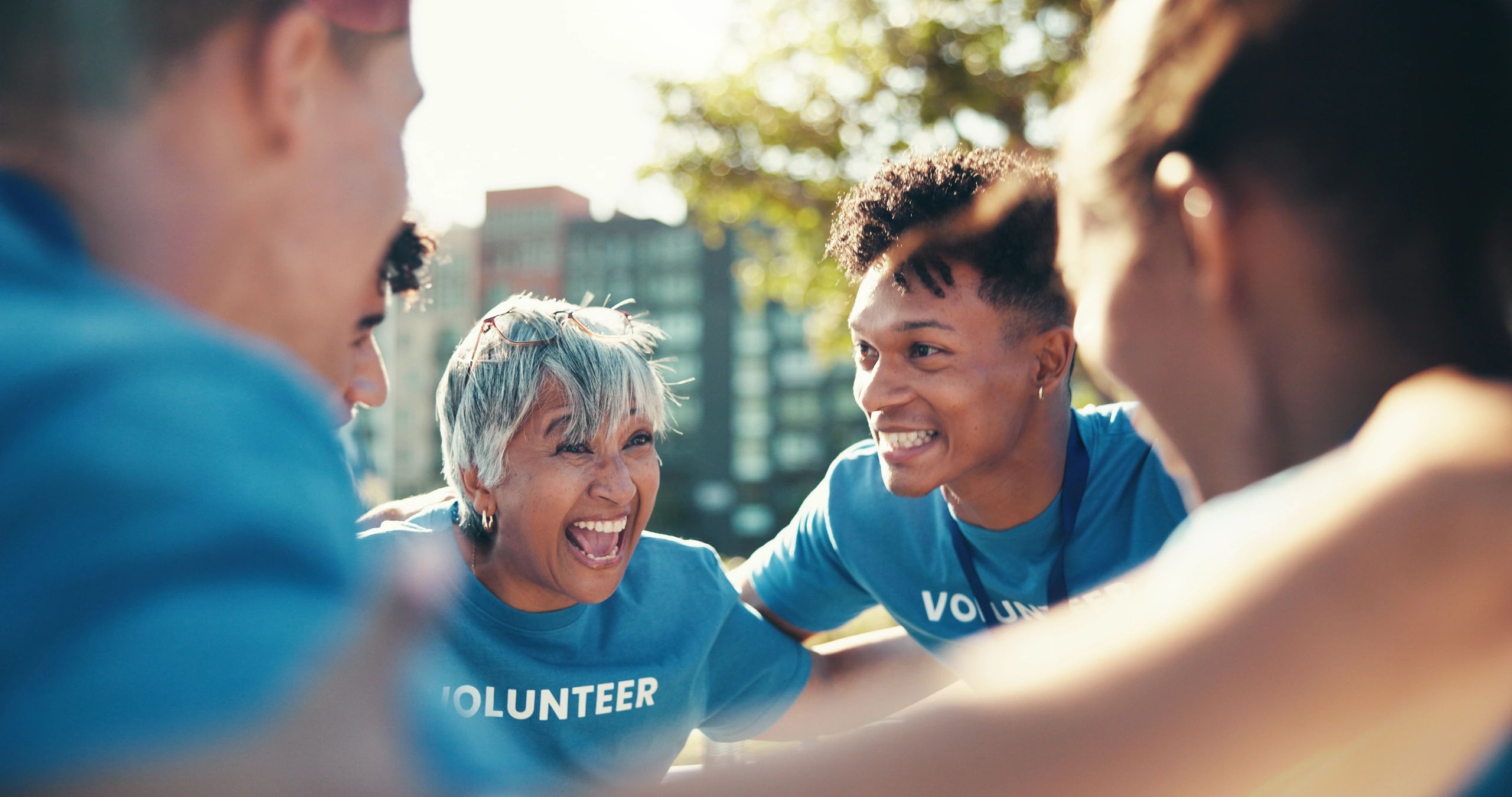 Group of volunteers enthusiastically supporting each other.