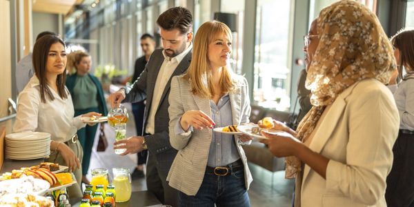 Colleagues enjoying snacks and drinks at a casual office gathering.