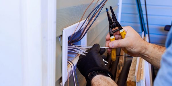 Electrical technician diagnosing system problems.