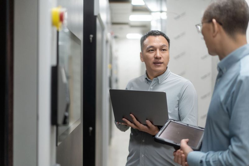 two computer engineer coworking in server room
