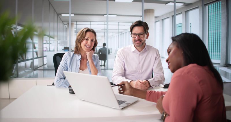 Happy Couple Discussing Financial Planning with Tax Accountant and Consultant