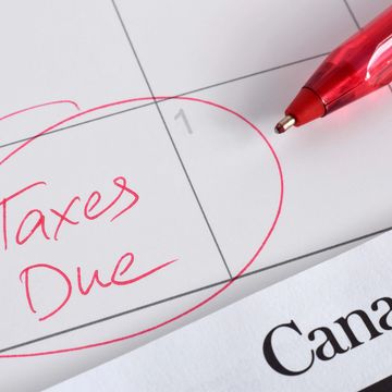 Red pen circles 'Taxes Due' on calendar next to Canadian tax document.