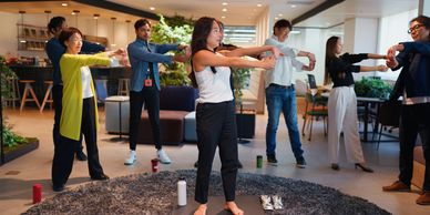 Group doing stretching exercises indoors.