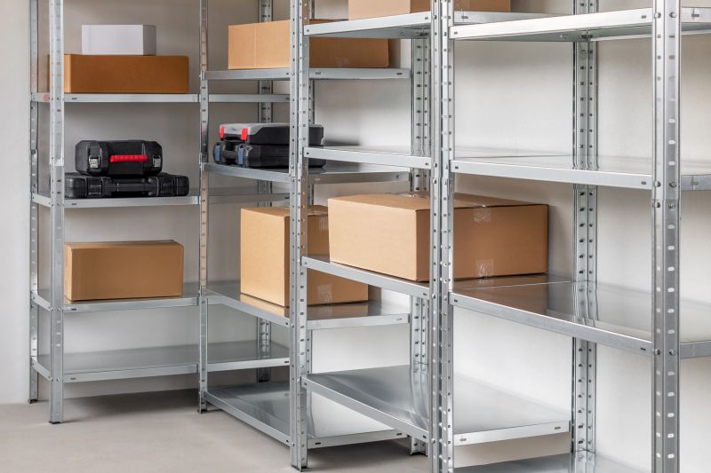 Metal warehouse shelves filled with different sizes of beige cardboard boxes and black plastic tool boxes. Storage concept.