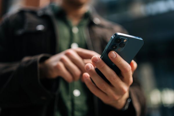 Person using a smartphone outdoors.