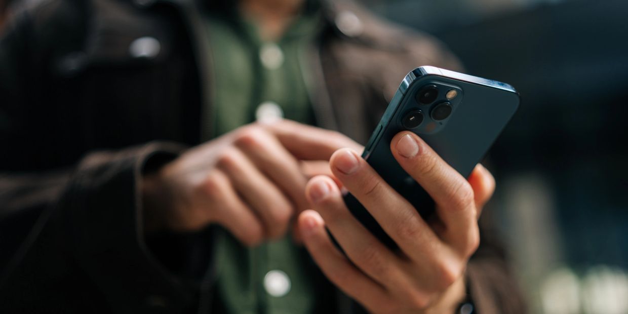 Person using a smartphone outdoors.