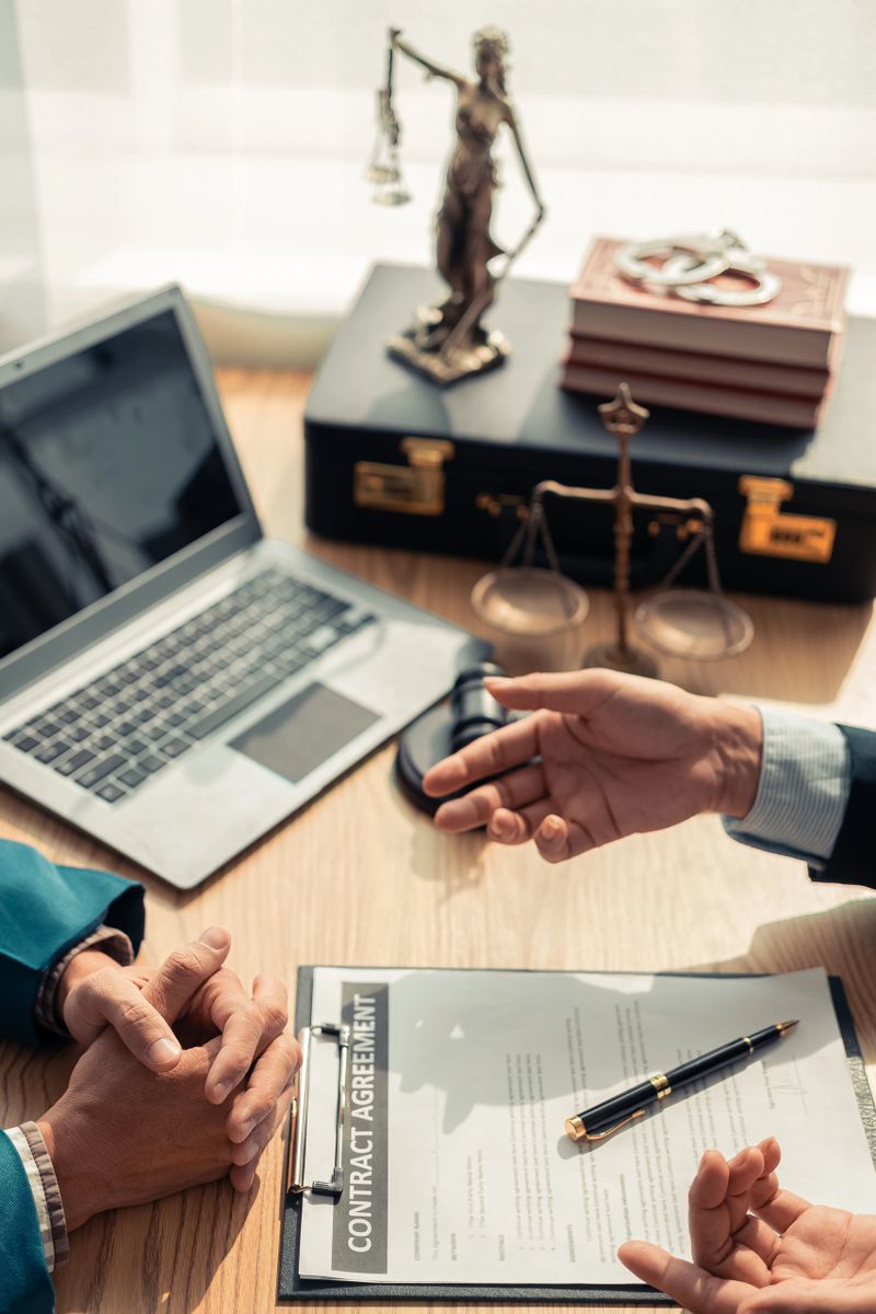 Meeting of business lawyers working on legal issues in the courtroom to help clients, lawyers working with notebooks, working with documents to prepare for litigation. Close-up vertical image