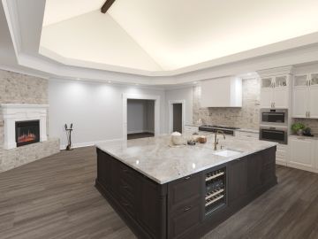 Modern kitchen with large marble island and fireplace.