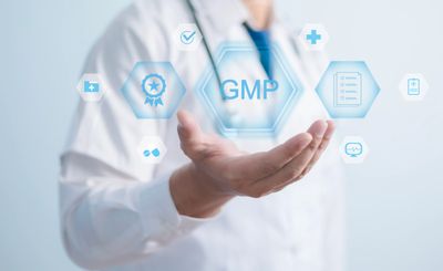 Healthcare professional presenting GMP concept with futuristic icons floating above hand.