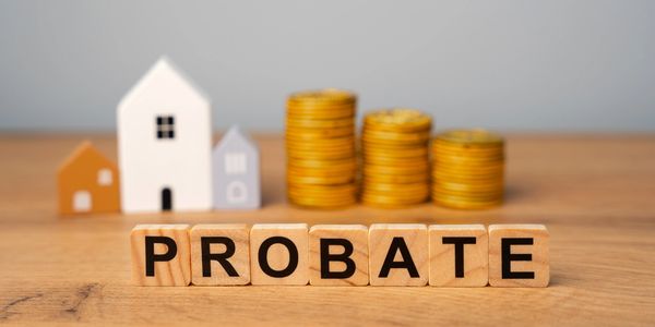 Blocks spelling 'PROBATE' with model houses and coins in background.