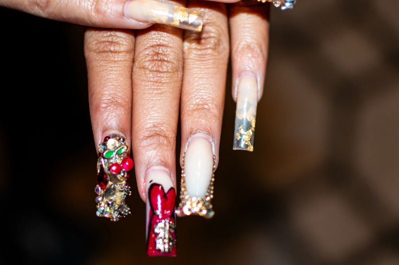 A close up of highly decorative nails that were painted at a nail shop.