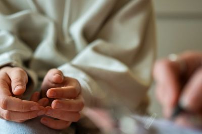 Close-up of hands in a calm, soft setting.
