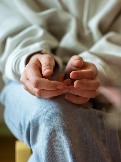 Hands representing emotional support and healing through DBT therapy in Denver.
